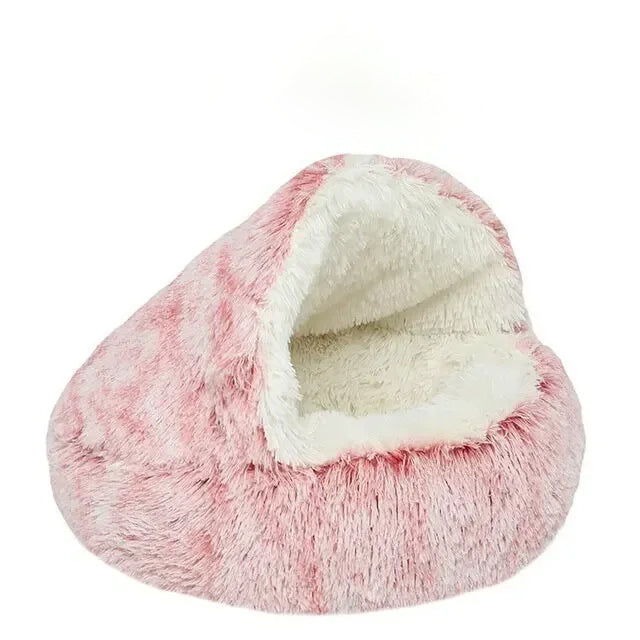 Pink and white fluffy pet bed on a white background