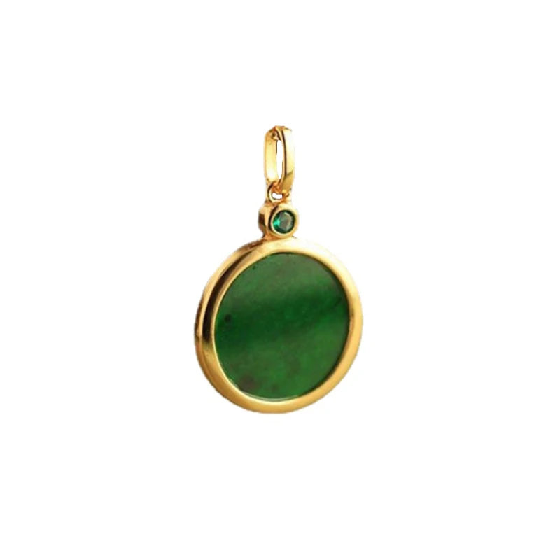 Gold pendant with a green stone on a white background