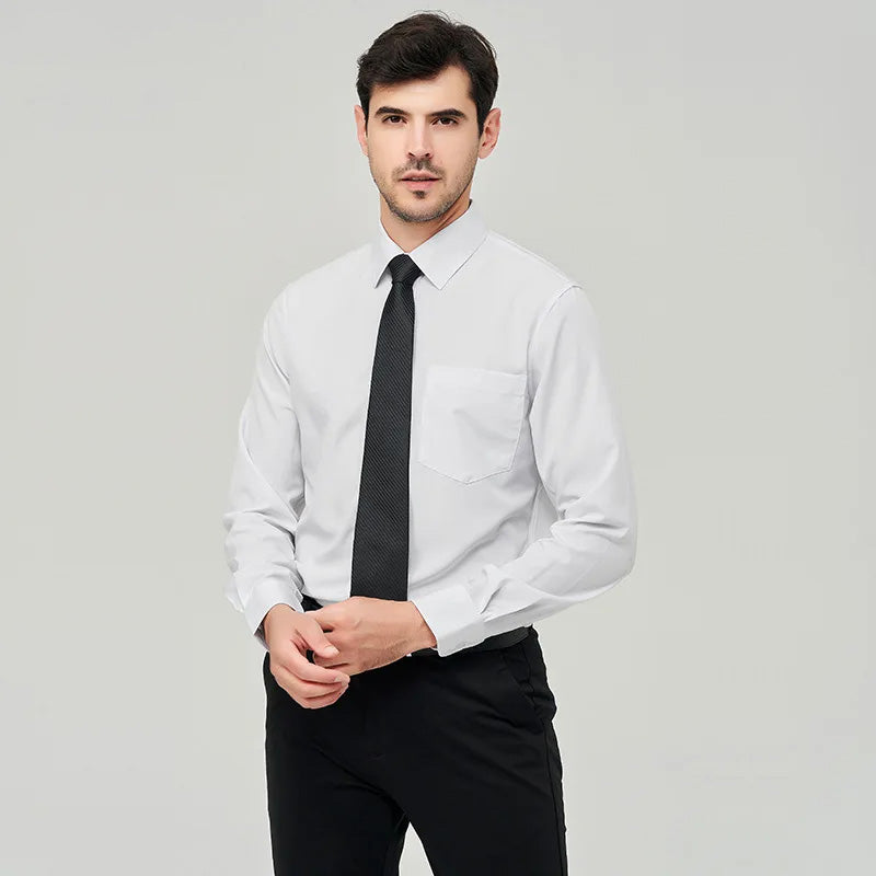 A front view of a man standing, wearing a white button up dress shirt, black tie, dark blue pants and a black belt.