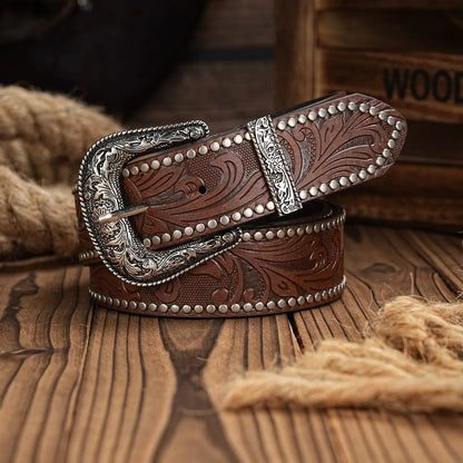 Brown leather belt with silver buckle on a wooden surface