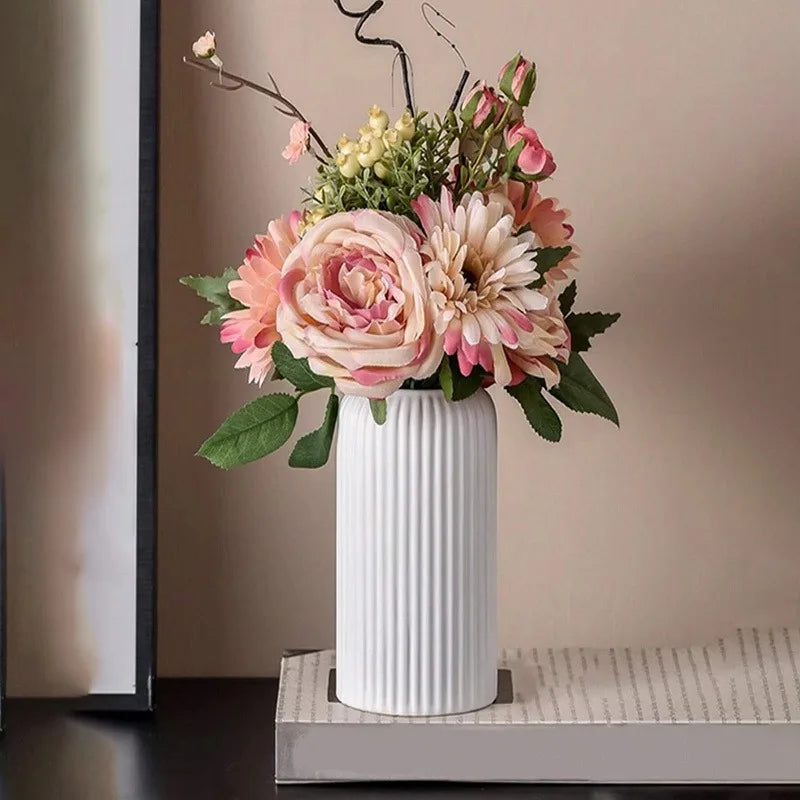 Floral arrangement in a white vase on a neutral background