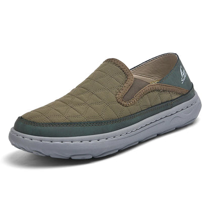 Green slip-on shoe with quilted design on a white background