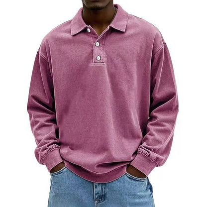 Person wearing a pink long-sleeve polo shirt on a white background