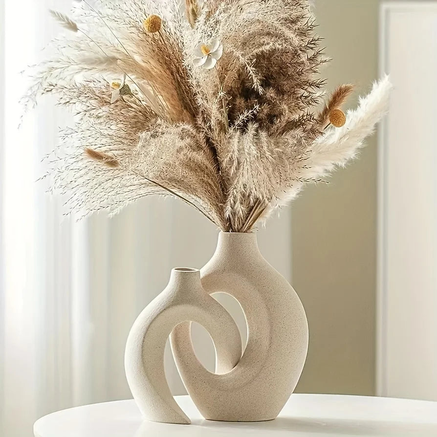 Decorative vase with dried pampas grass on a white surface
