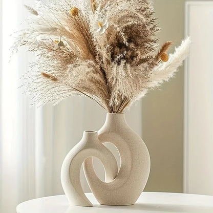 Decorative vase with dried pampas grass on a white surface