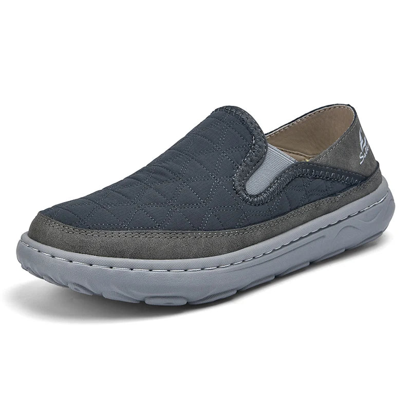 Navy and gray slip-on shoe on a white background