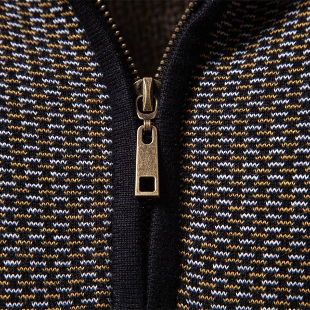 Close-up of a zipper on a textured fabric with a geometric pattern.