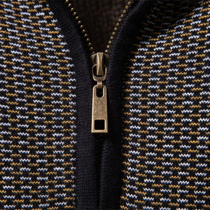 Close-up of a zipper on a textured fabric with a geometric pattern.