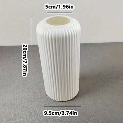 White textured cylindrical object with measurements on a gray surface