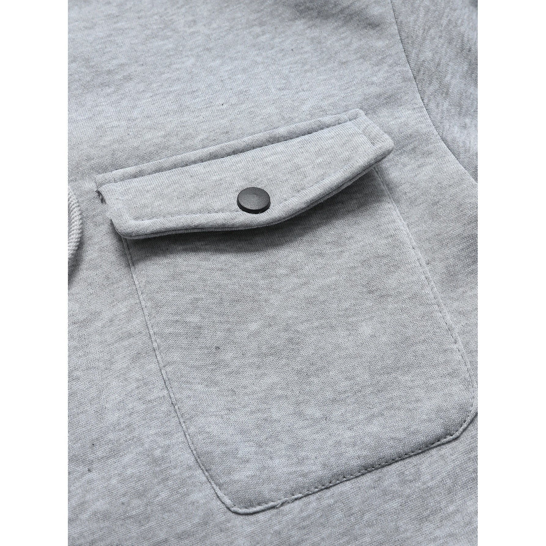 Close-up of a gray pocket on a garment with a button.