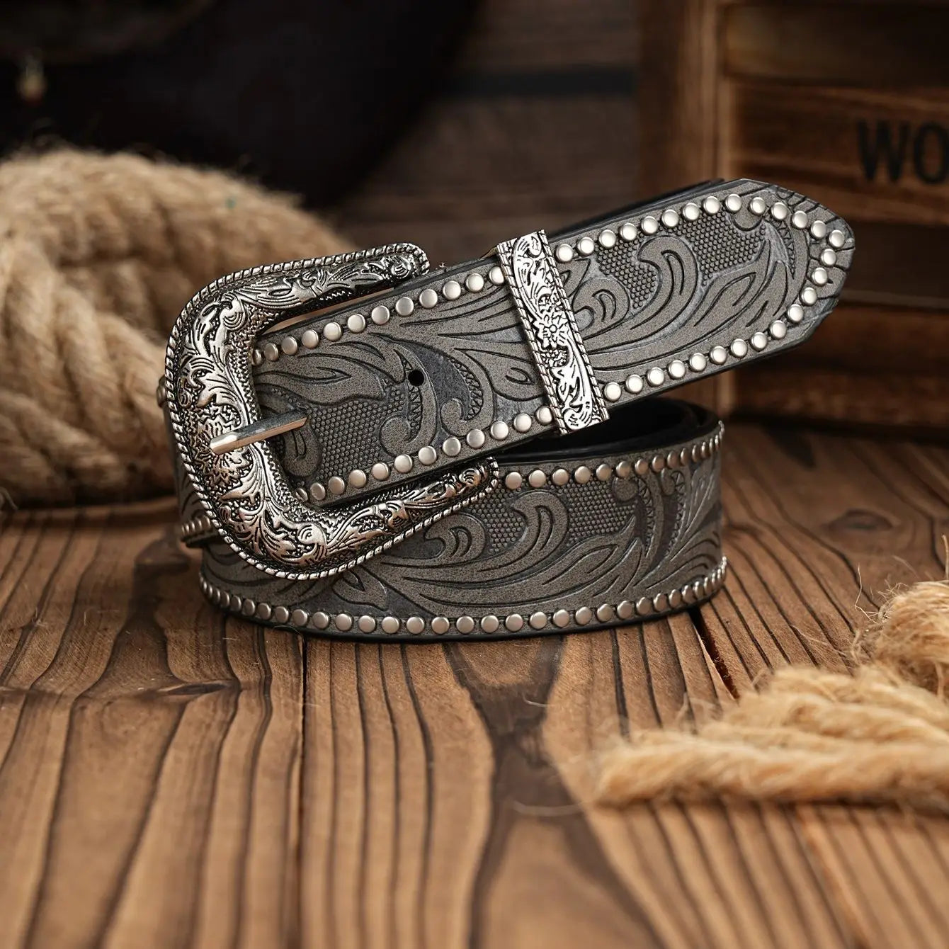 Decorative belt with intricate design on a wooden surface