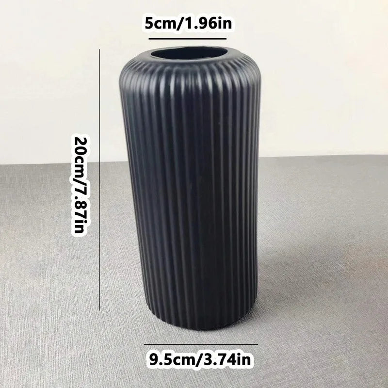 Black ribbed cylindrical object with measurements on a gray background