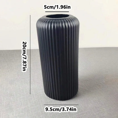 Black ribbed cylindrical object with measurements on a gray background