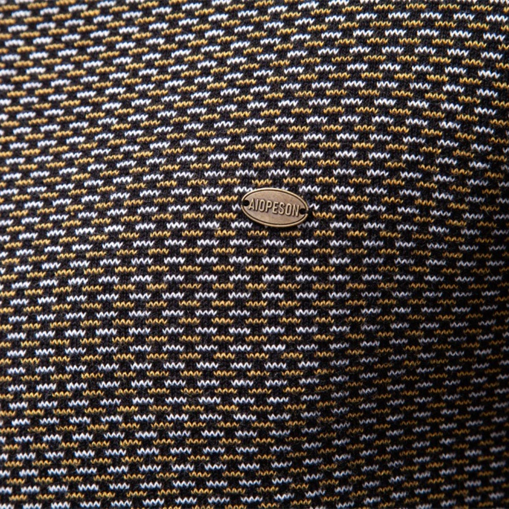 Close-up of a patterned fabric with a brand logo in the center.