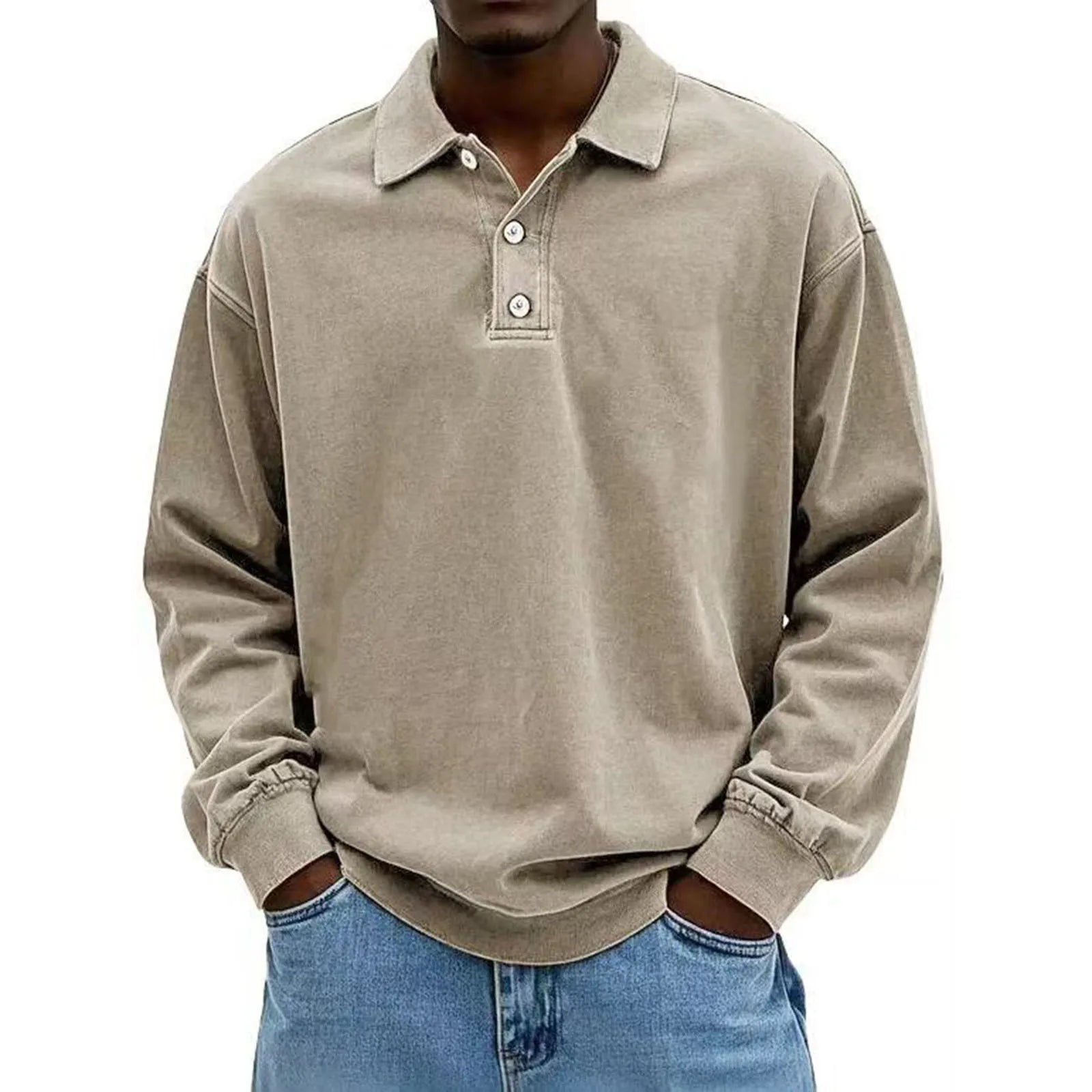 Person wearing a beige long-sleeve polo shirt and blue jeans on a white background