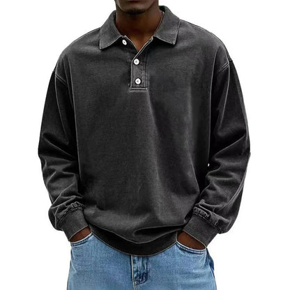 Person wearing a dark gray long-sleeve polo shirt with rolled-up sleeves on a white background