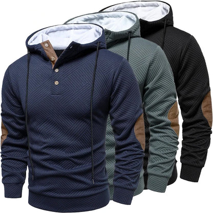 Three hoodies in navy, gray, and black with brown accents on a white background